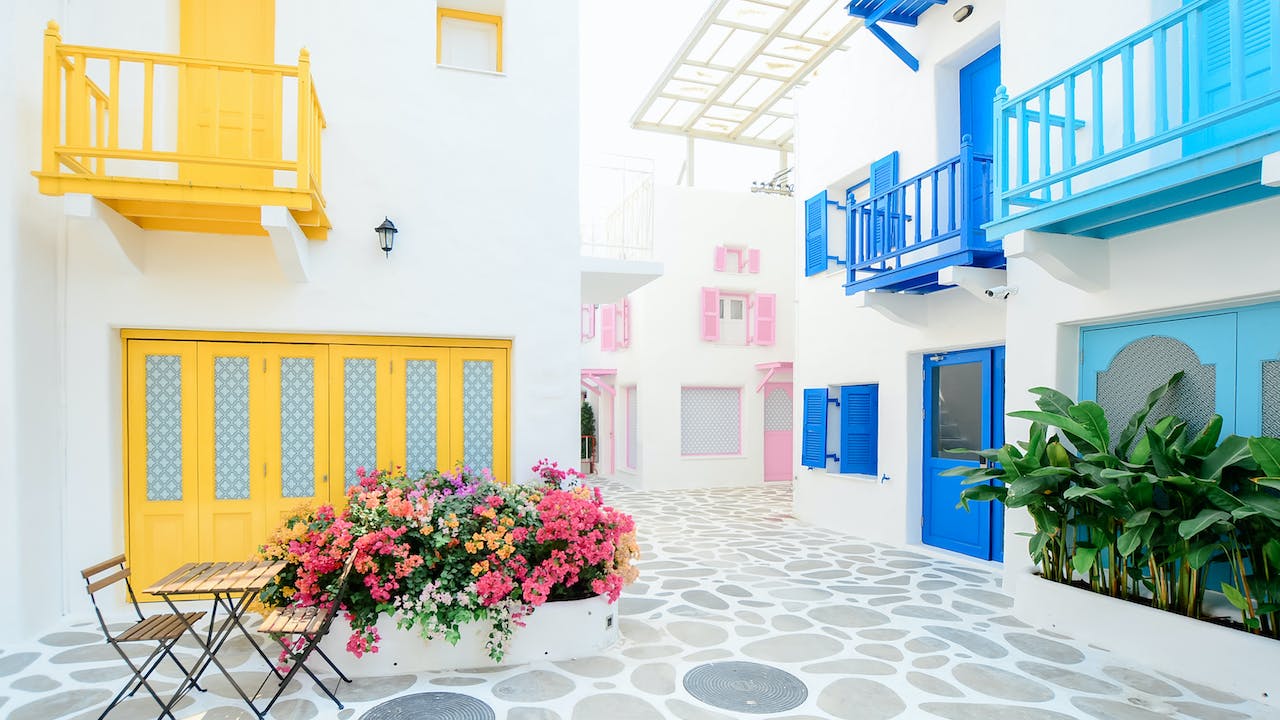 Architectural photography of three pink blue and yellow buildings